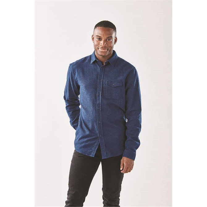 A long sleeve twill shirt in navy with a button-up front and a chest pocket, featuring a logo.