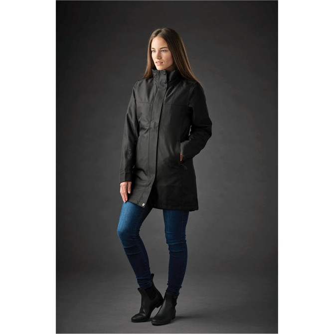A black Women's Montauk System Jacket is displayed on a model, paired with blue jeans and ankle boots.