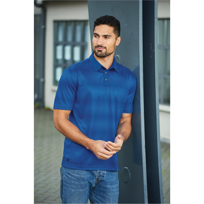 A blue striped polo shirt with a collar, featuring a logo, worn by a man standing outdoors.