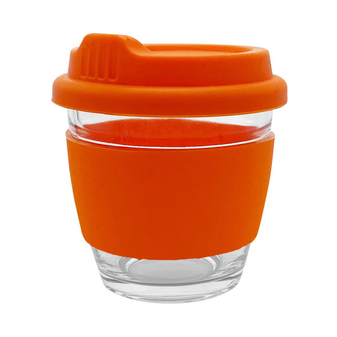 A reusable coffee cup with a clear glass body and an orange silicone sleeve and lid. It features a logo.