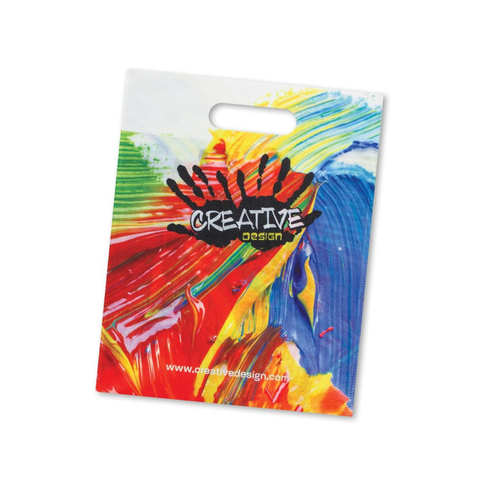 A tote bag with a colorful abstract paint design and the logo "CREATIVE DESIGN" prominently displayed.