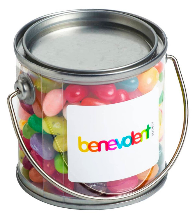 A small clear PVC bucket filled with colourful JELLY BELLY jelly beans, featuring a silver handle and a branding label.