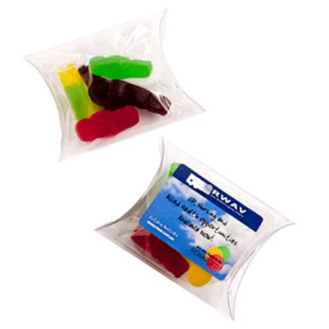 A pillow pack containing assorted jelly babies in red, green, and yellow. The pack has a logo on it.