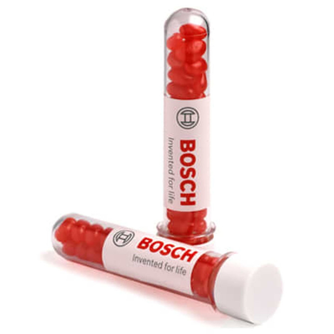 A test tube containing red jelly beans, with a branded label and transparent cap.