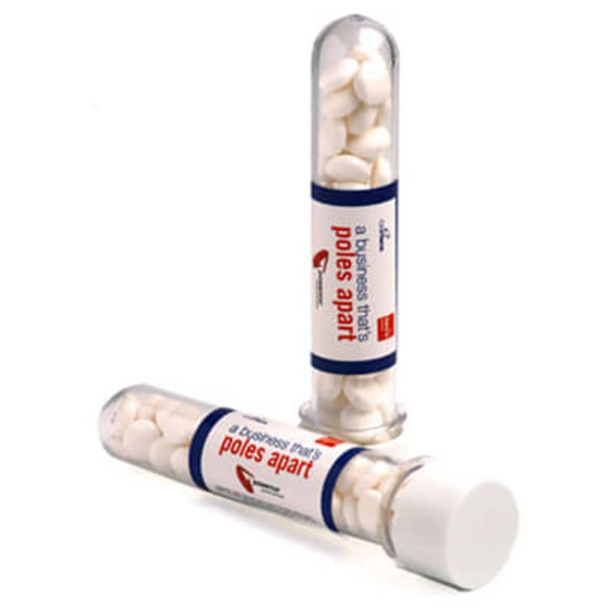 Test tubes filled with white mints, featuring a clear container and a white cap. One tube is upright, the other is lying down.