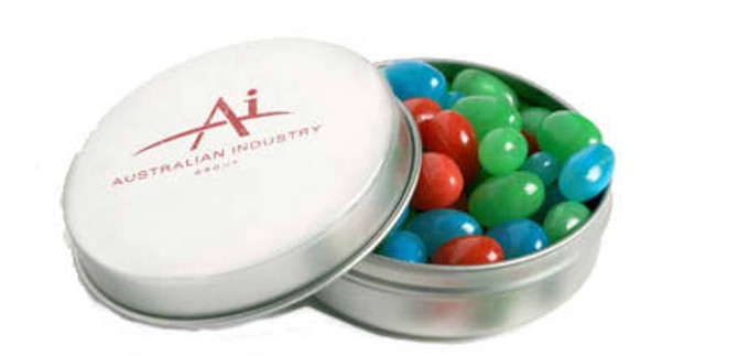 A tin containing mini jelly beans in red, green, and blue colours, with a branded white lid.
