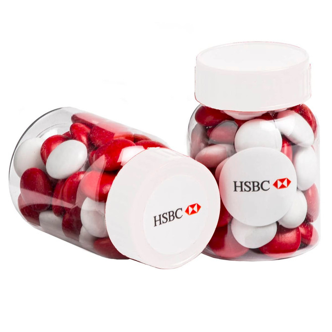 Two clear jars filled with red and white choc beans, each with a white lid and a logo on the front.