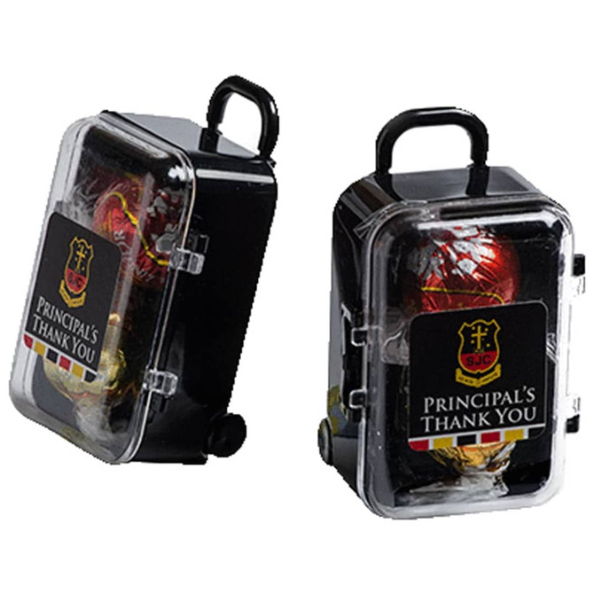 A small black carry-on case with a handle, containing two Lindt chocolate balls. The case features a logo.