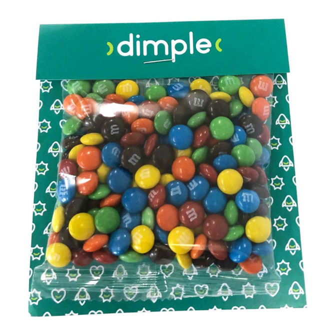 A bag of colourful M&M chocolates in various shades including red, blue, green, orange, and brown, with branding.