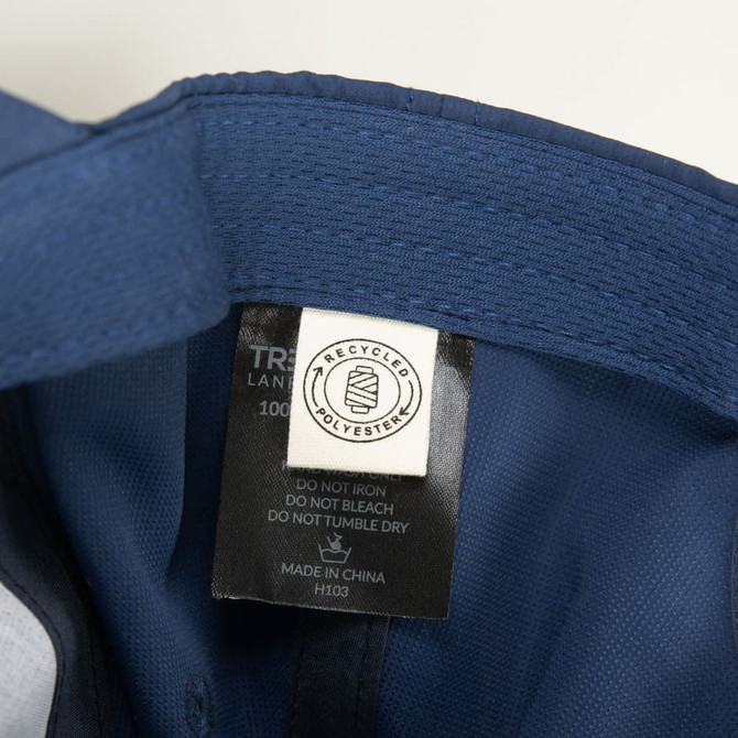 A navy cap with a tag indicating it is made from recycled materials. It features a logo inside.