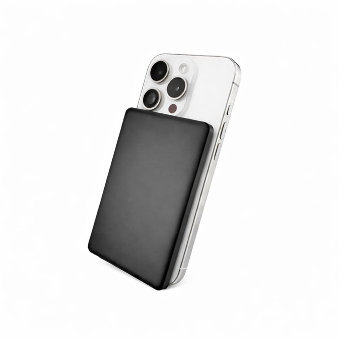 A black solid-state power bank is positioned against a silver smartphone, highlighting its sleek design and portable size.
