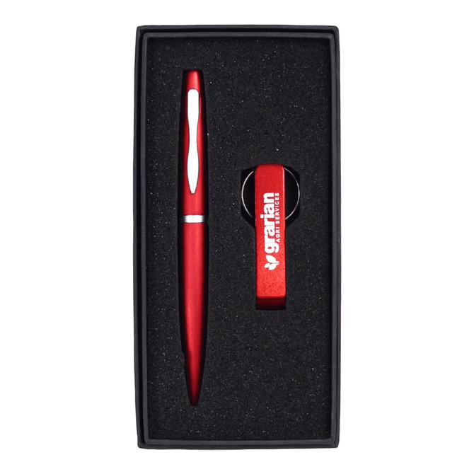 A drink bottle opener keyring and a red pen, both presented in a black gift box with foam insert.