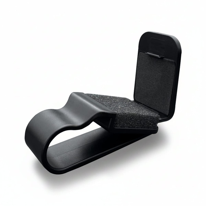 A black car visor sunglass holder with foam padding and a clip design for secure attachment.
