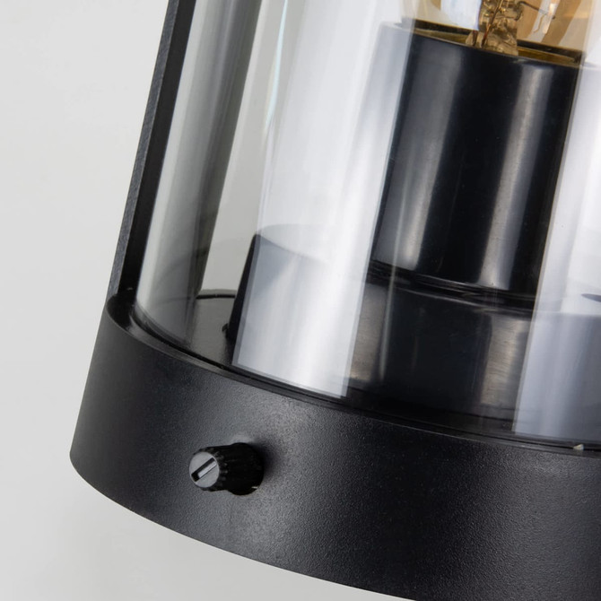 A black keepsake halo lantern with a glass shade and a decorative filament bulb, featuring a control knob at the base.