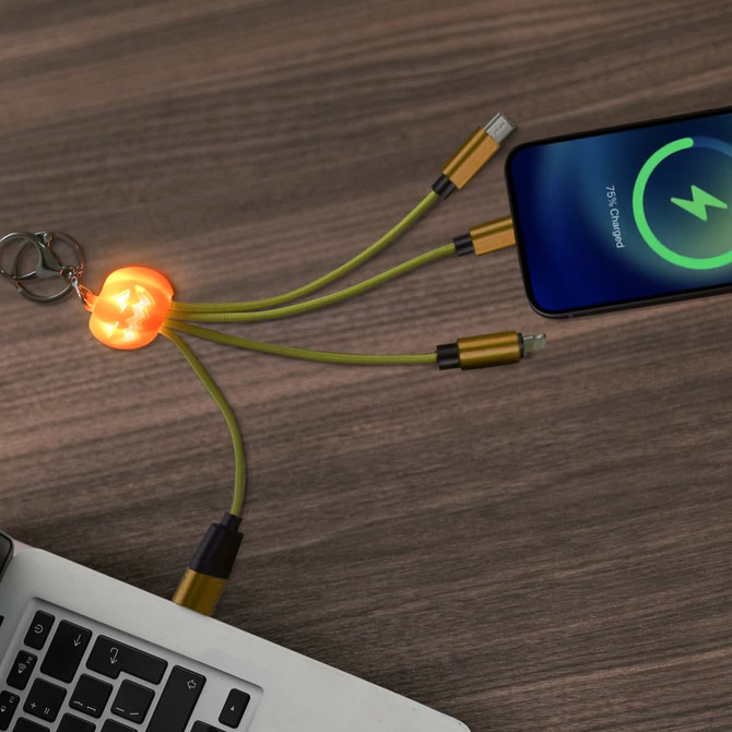 A custom-shaped light-up charging cable in yellow and orange, featuring a keyring attachment, displayed on a wooden surface.