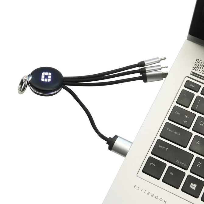 A round-shaped light-up charging cable in black with multiple connectors, plugged into a laptop's USB port.