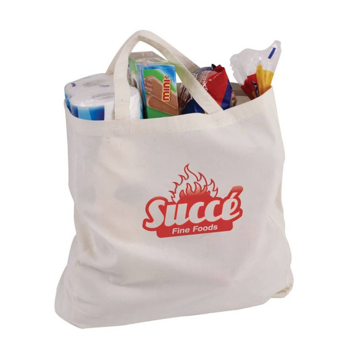 A cream-coloured calico bag with a gusset, filled with various grocery items, featuring a logo.