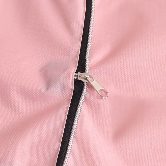 A close-up of a pink foldable tote bag featuring a zipper and a contrasting black lining.