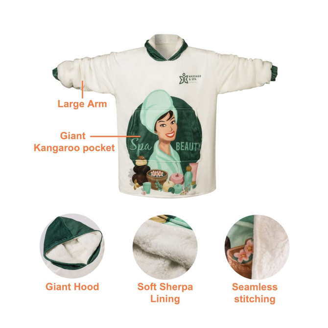 A wearable blanket in white with a green hood and giant kangaroo pocket, featuring a spa-themed graphic design.