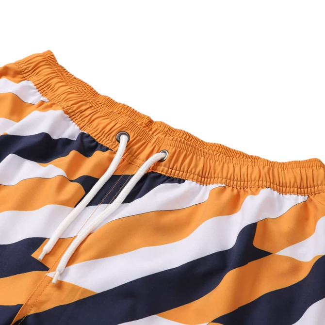 Women's board shorts in orange, navy, and white with a drawstring and pocket, featuring a wave pattern.