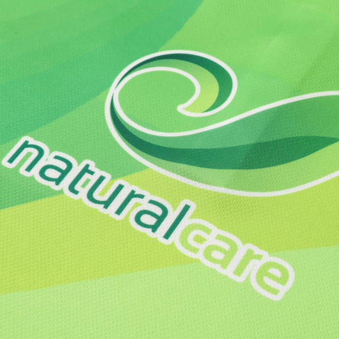 A green polo shirt featuring a swirling logo and the word "naturalcare" in white.