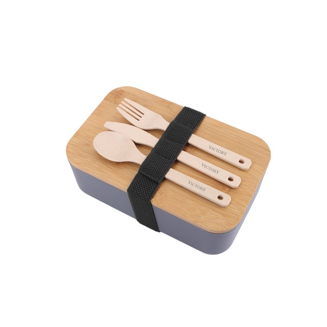 A lunch box in grey with a bamboo cover, featuring wooden utensils secured by a black strap. It has a branding logo.