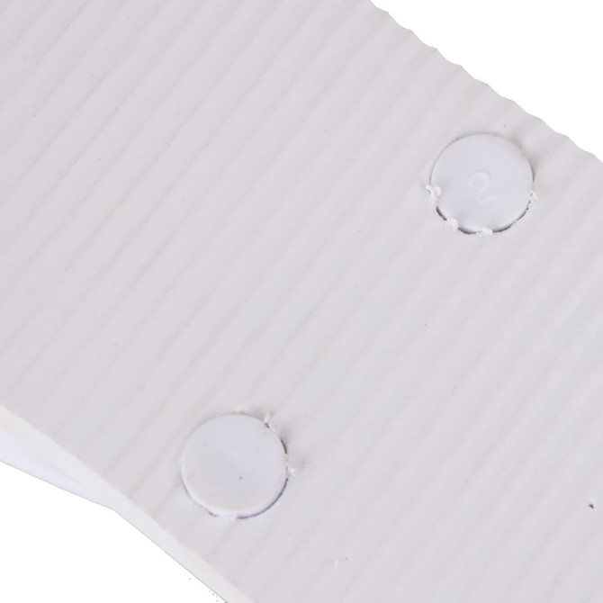 A close-up of white EVA material with ribbed texture and circular indentations. The image features a logo.
