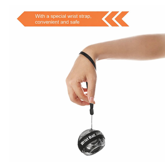 A black and grey wrist ball with a wrist strap, held by a hand, designed for leisure and outdoor activities.