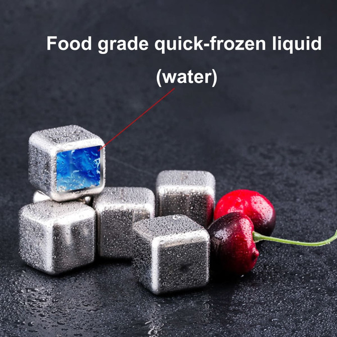 A set of six stainless steel ice cubes, featuring a blue inner core, alongside fresh cherries.