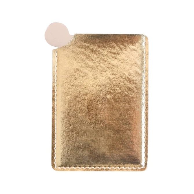 A gold portable mirror in a sleek, metallic case with a rounded edge and a small cutout for easy access.