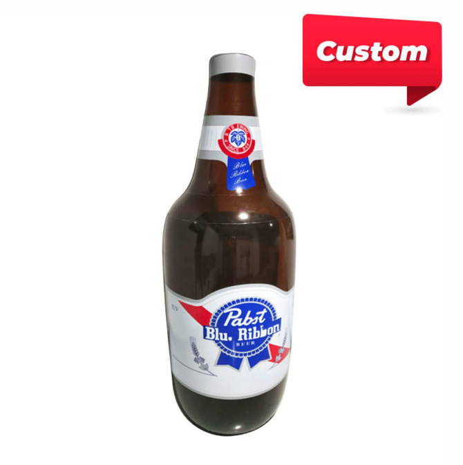 A large inflatable drink bottle in brown, red, white, and blue, with a logo featured on the front.