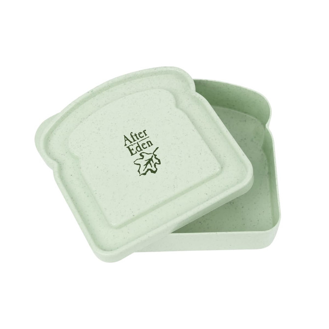 A portable lunch box in light green bamboo fibre, featuring a lid and a logo inside.