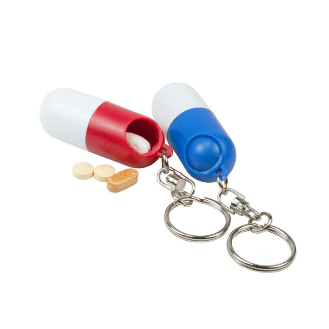 A red and white pill capsule keychain and a blue and white pill capsule keychain, each with a keyring attachment.