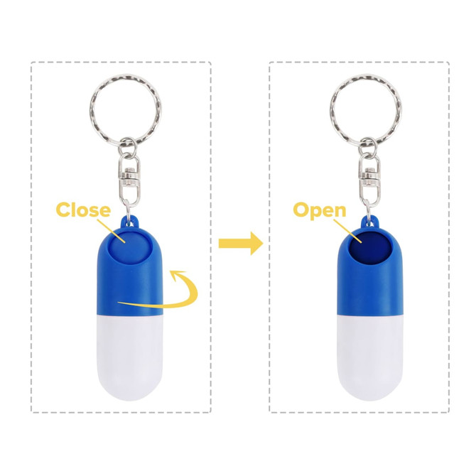 A blue and white pill capsule keychain with a round opening mechanism and a metallic keyring attachment.