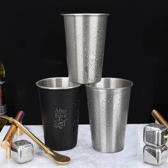 Three stainless steel cups in silver and black, featuring a logo, with condensation on their surfaces.