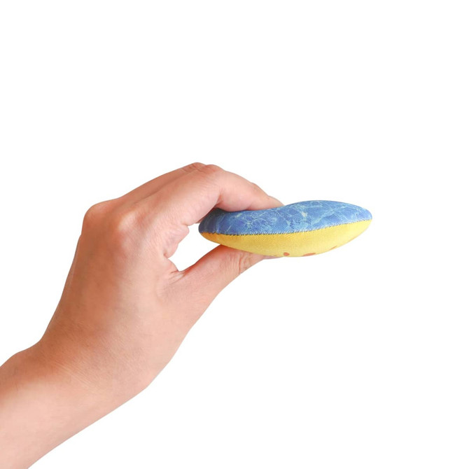 A hand holds a blue and yellow water bouncing disc with a textured surface. The disc has a logo on it.