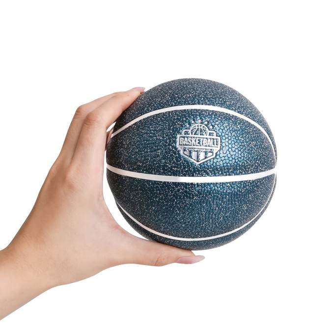 A hand holds a dark blue mini basketball with a textured surface and white lines, featuring a logo.