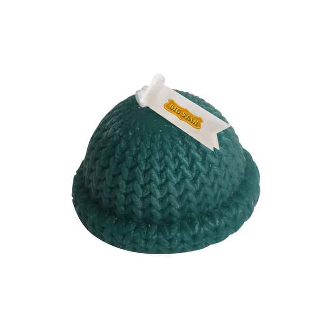 A teal hat-shaped candle with a textured knit design and a ribbon detail, featuring a small logo on it.