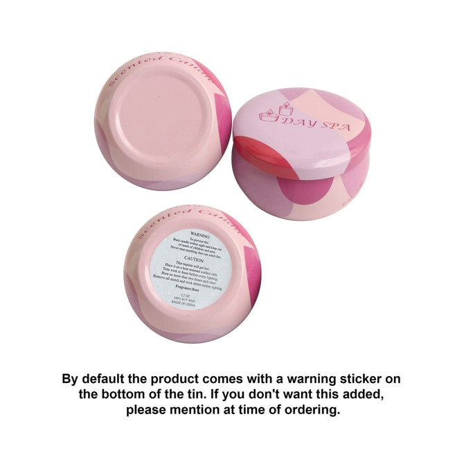 A set of pink tin candles with a decorative design, featuring warning stickers on the bottoms.