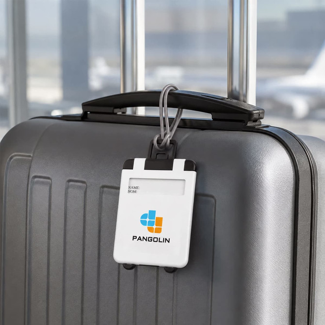 A white ABS luggage tag attached to a grey suitcase, featuring a logo and adjustable strap.