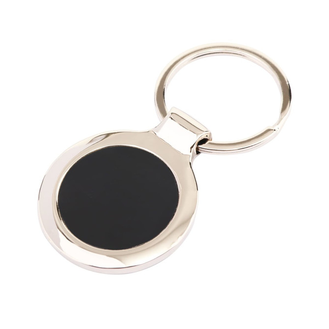 A metallic keyring with a round, glossy black surface and a silver circular attachment.