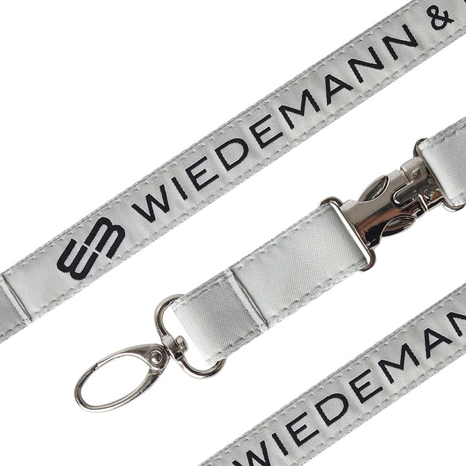 A detailed woven lanyard in silver with a metal clip and attachment ring, featuring branding along the length.
