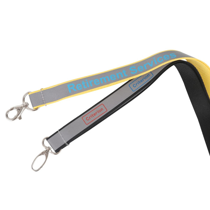 A safety lanyard in black, grey, and yellow, featuring clips and a logo on the straps.