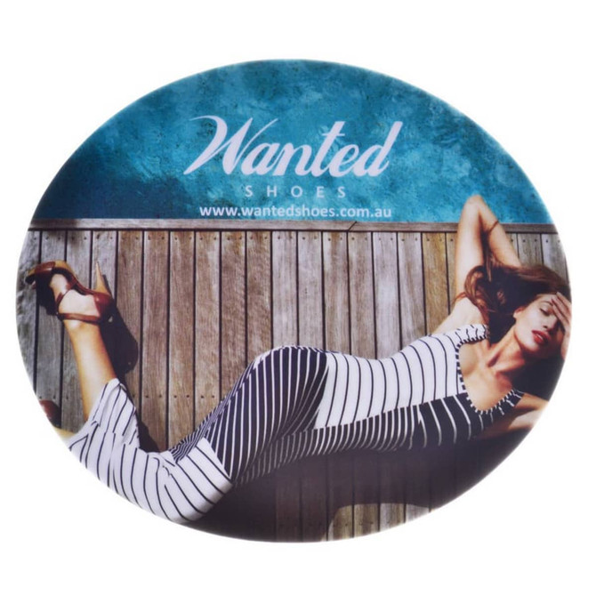 A round mouse mat featuring a woman in a striped dress lying on a wooden surface, with a logo at the top.