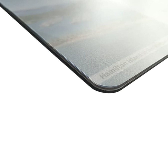 A mouse mat featuring a landscape design with a grey finish and rounded edges. It includes a logo or branding.