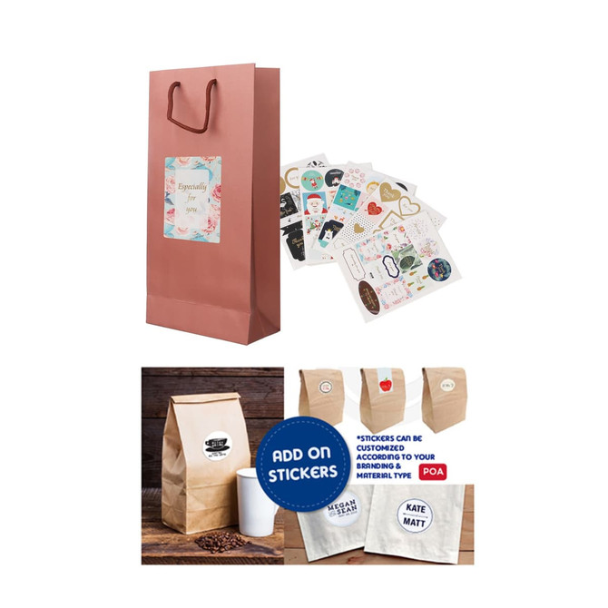 A wine bottle paper bag in pink with handles, accompanied by decorative stickers and kraft paper bags.