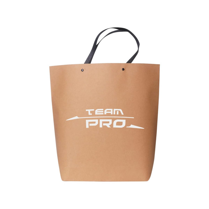 A large brown boutique paper bag with black handles and a logo on the front.
