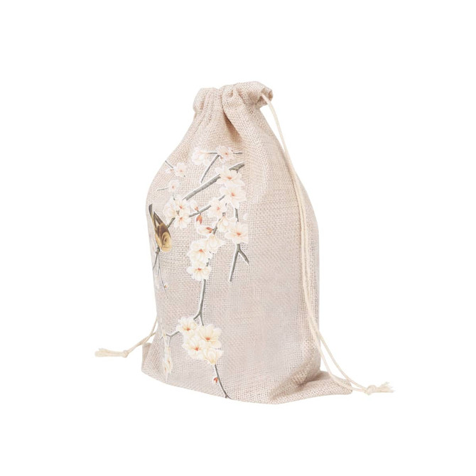 A small jute produce bag with a floral design in beige tones and a drawstring closure. It features a logo.