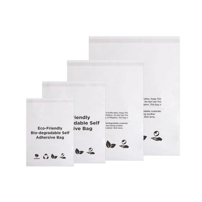 A set of four white biodegradable self-adhesive bags of varying sizes, featuring a logo and eco-friendly symbols.