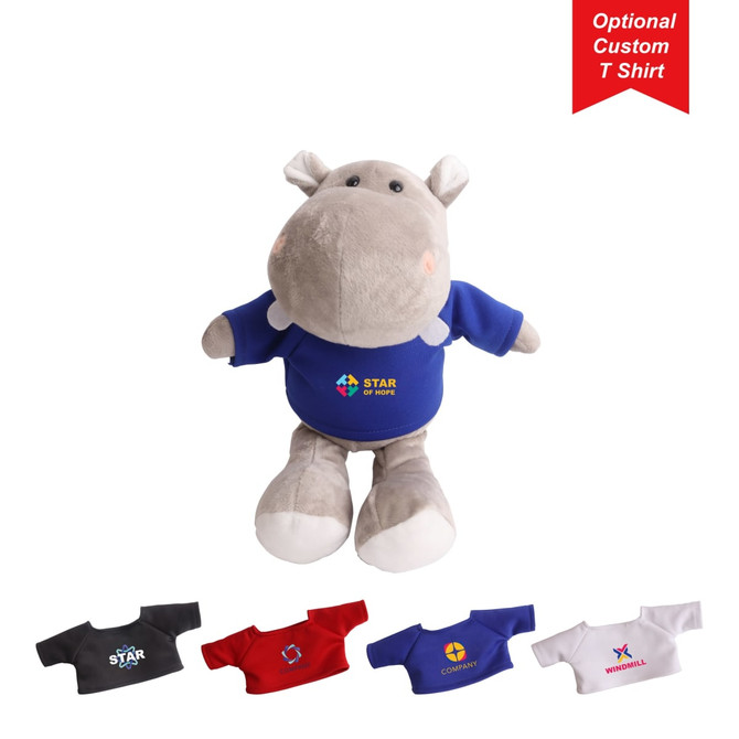 A grey hippopotamus plush toy wearing a blue shirt with a logo, accompanied by various fabric T-shirts in different colours.